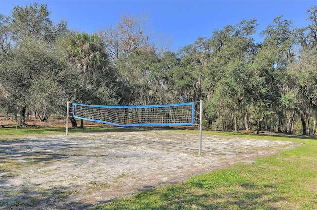 view of home's community featuring a lawn and volleyball court