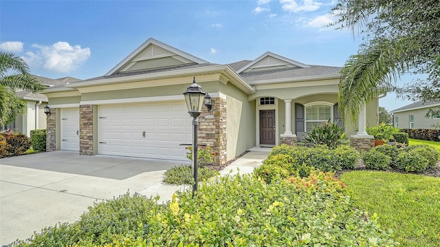 single story home featuring stucco siding, an attached garage, stone siding, and concrete driveway