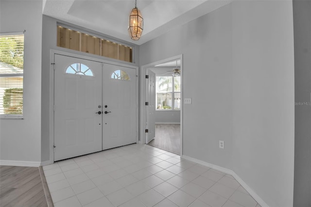 entrance foyer featuring light wood-type flooring, ceiling fan, and plenty of natural light