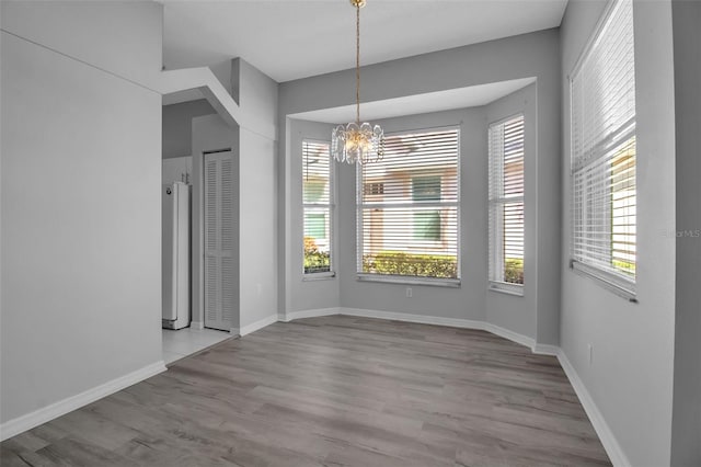 interior space featuring a notable chandelier and light wood-type flooring