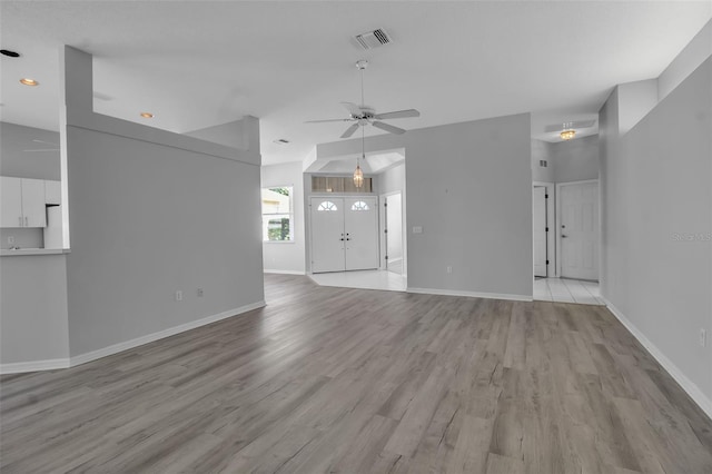 unfurnished living room featuring ceiling fan and light hardwood / wood-style flooring