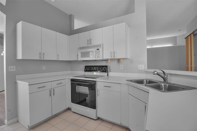 kitchen featuring light tile patterned flooring, sink, white appliances, and white cabinetry