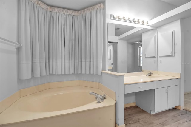 bathroom featuring wood-type flooring, vanity, and a bathing tub