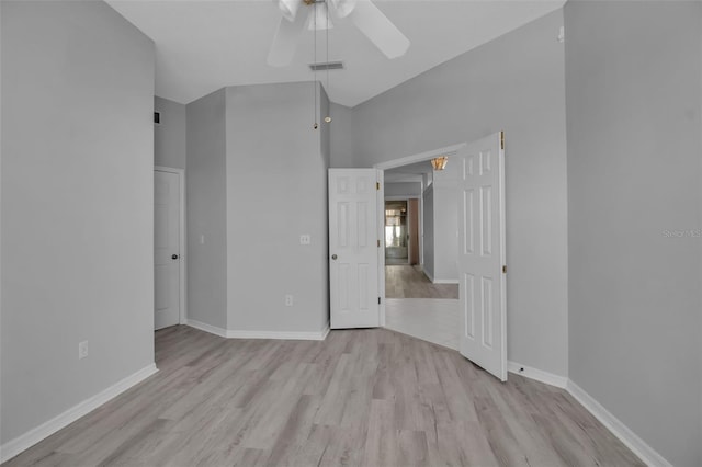 unfurnished bedroom with high vaulted ceiling, light hardwood / wood-style floors, and ceiling fan