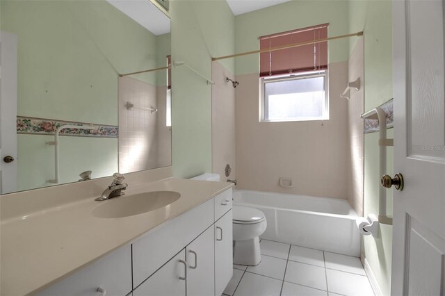 full bathroom featuring tiled shower / bath, vanity, toilet, and tile patterned floors