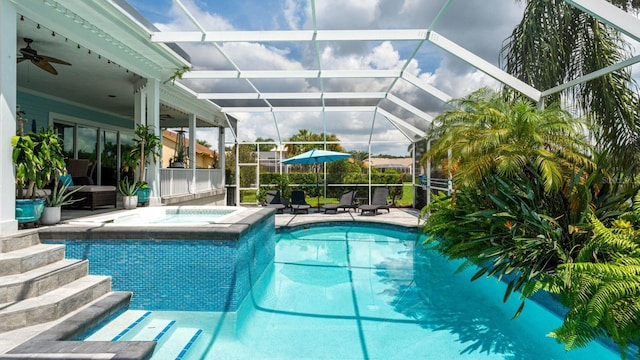 view of pool with a patio, an in ground hot tub, a lanai, and ceiling fan