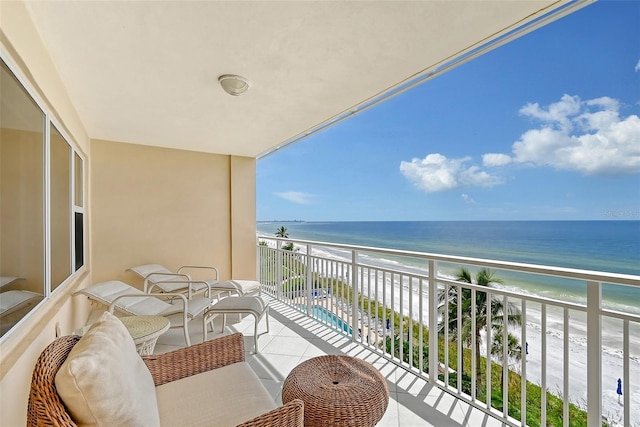 balcony with a view of the beach and a water view