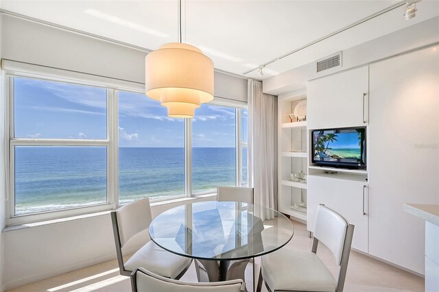 dining space with visible vents, built in shelves, and rail lighting