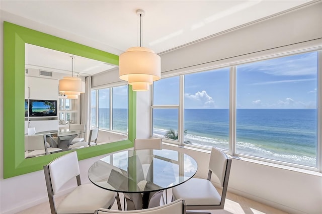 dining area featuring visible vents and a beach view