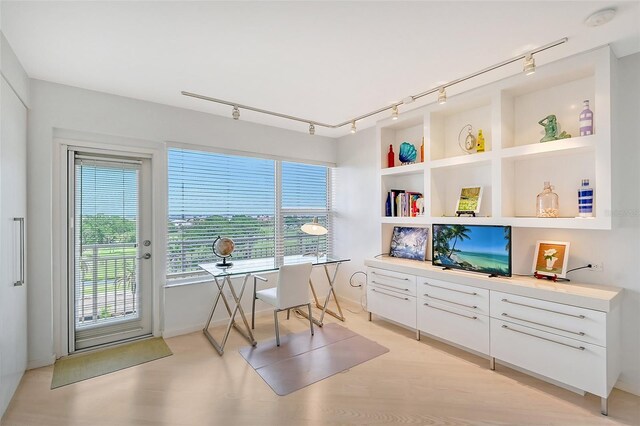 office space featuring built in shelves and plenty of natural light