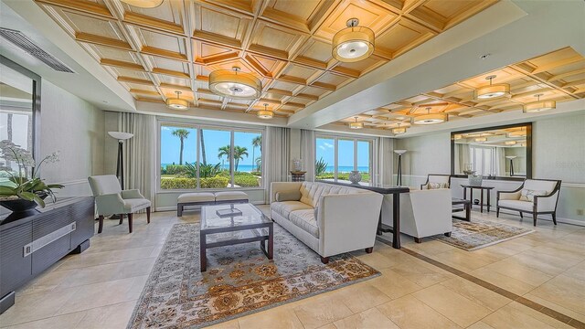 living area featuring light tile patterned floors, visible vents, baseboards, and coffered ceiling