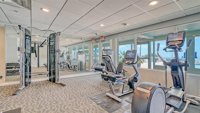 workout area with carpet flooring, recessed lighting, and a paneled ceiling