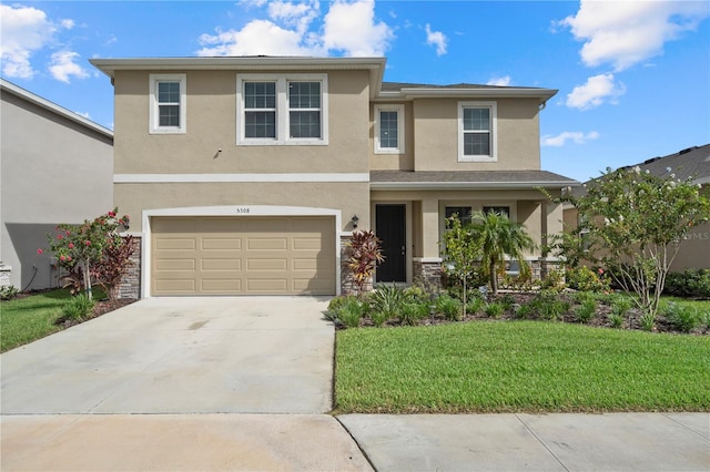 view of front of property featuring a garage and a front lawn