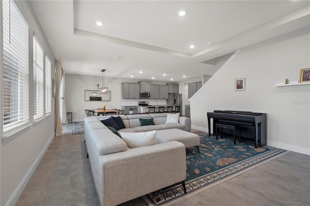 living room featuring a raised ceiling