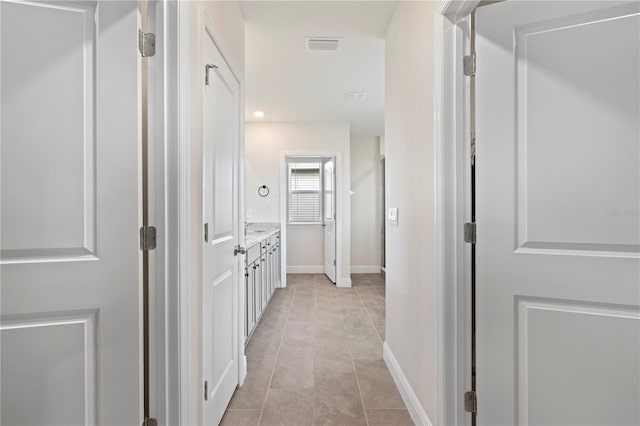 corridor with light tile patterned floors