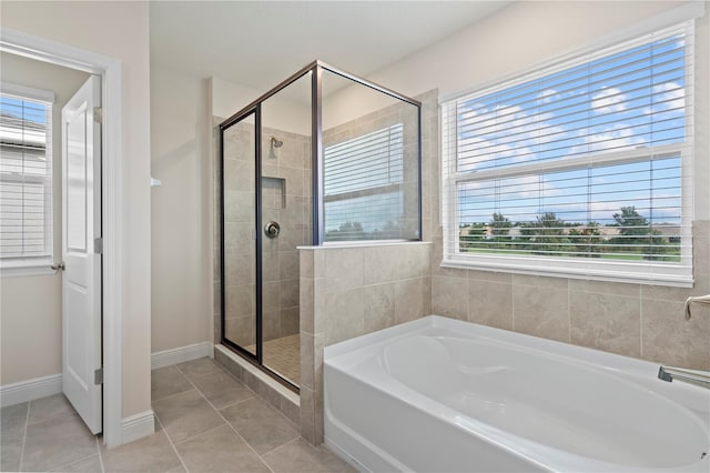 bathroom with tile patterned floors and plus walk in shower