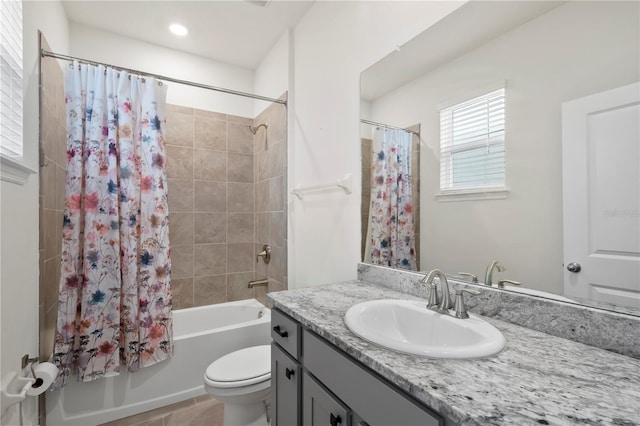 full bathroom featuring tile patterned flooring, vanity, toilet, and shower / bath combo