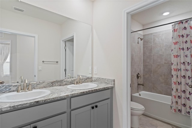 full bathroom with tile patterned flooring, vanity, toilet, and shower / bath combination with curtain