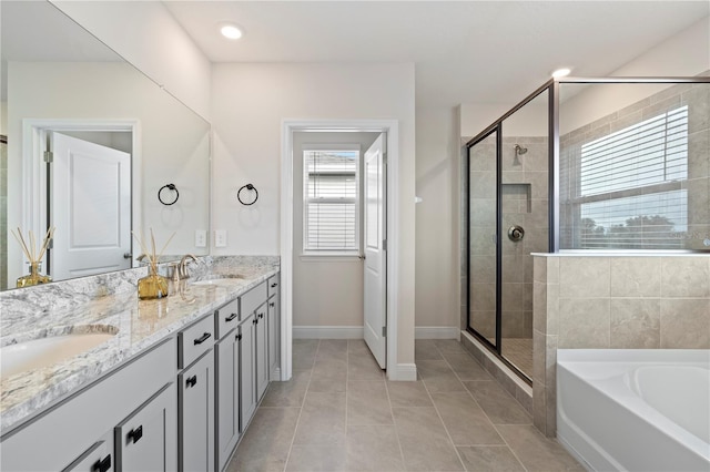 bathroom featuring vanity, plus walk in shower, and tile patterned floors