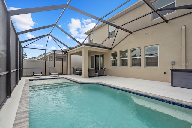 view of swimming pool featuring a lanai and a patio area