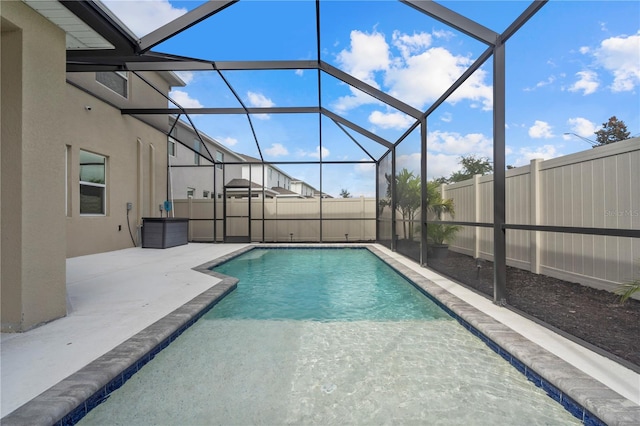 view of swimming pool with a lanai and a patio area