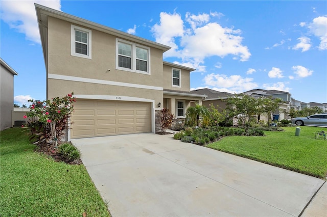 view of front of property with a garage and a front lawn