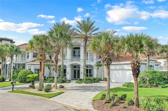 mediterranean / spanish-style house with a front lawn