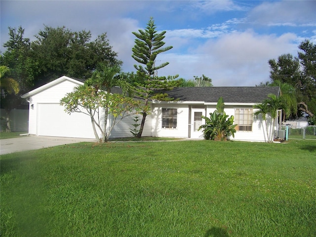 ranch-style home featuring a garage and a front lawn