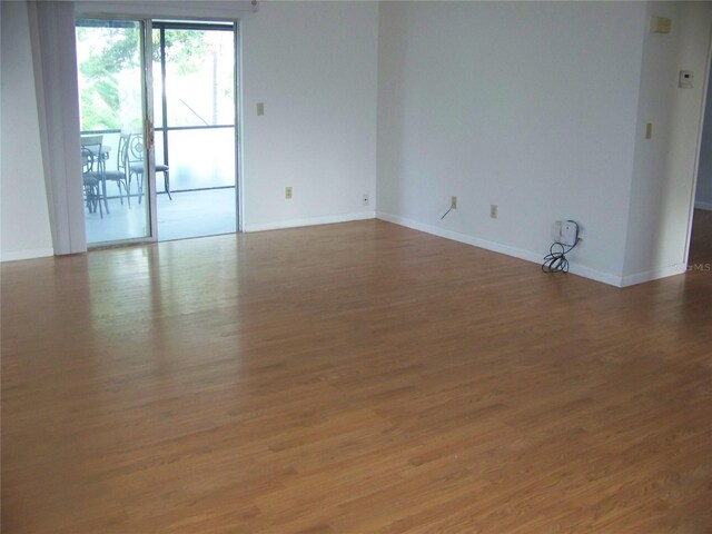 empty room with wood-type flooring