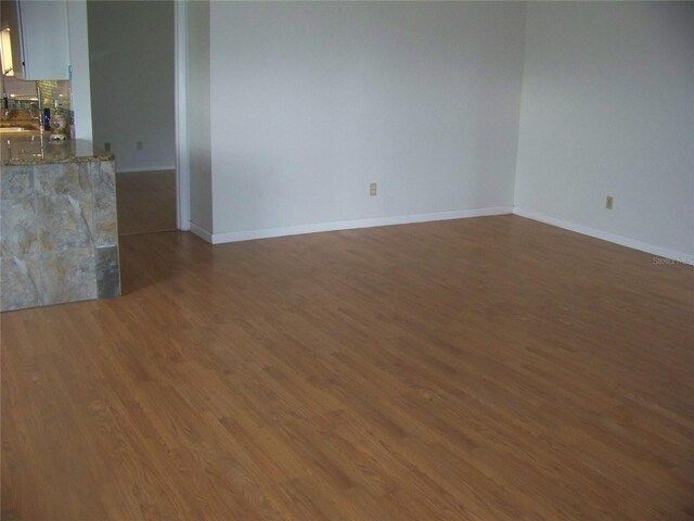 spare room featuring hardwood / wood-style flooring and sink