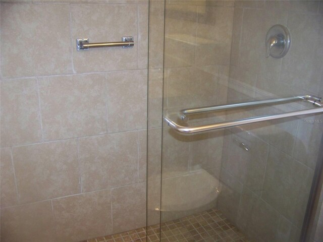 bathroom featuring a shower with door