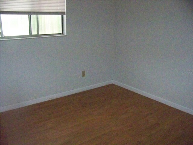 empty room with hardwood / wood-style floors