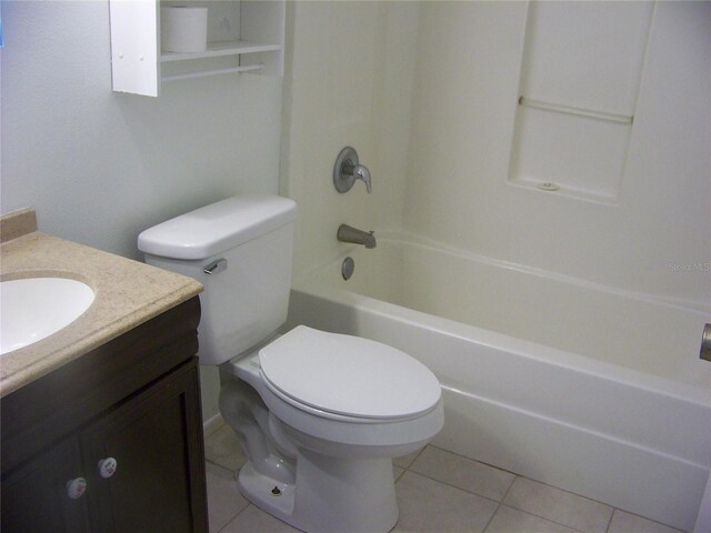 full bathroom featuring vanity, toilet,  shower combination, and tile patterned flooring