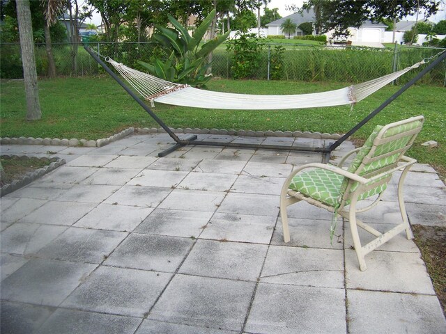 view of property's community with a yard and a patio area