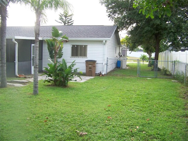 rear view of house with a yard and a patio