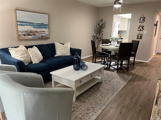 living room with ceiling fan and dark hardwood / wood-style floors