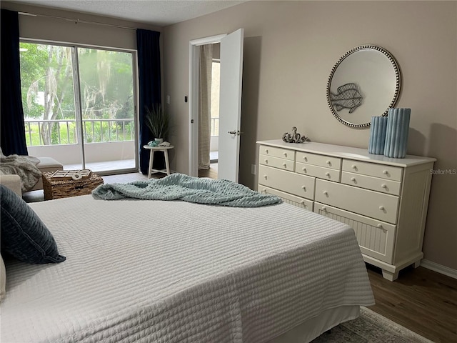 bedroom featuring multiple windows and dark hardwood / wood-style floors