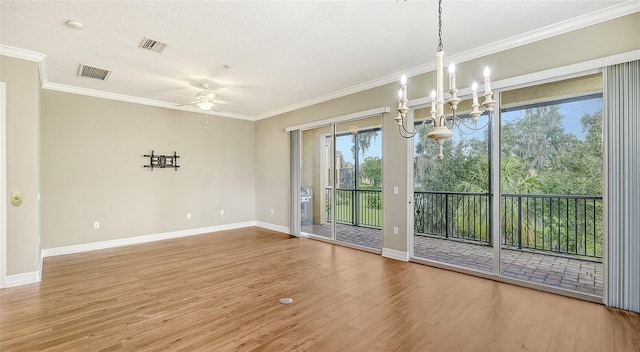 unfurnished dining area featuring ceiling fan with notable chandelier, ornamental molding, and light hardwood / wood-style flooring