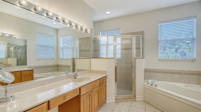 bathroom with a wealth of natural light, vanity, tile patterned floors, and shower with separate bathtub