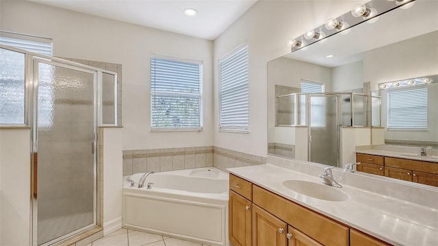 bathroom featuring vanity, tile patterned floors, and plus walk in shower