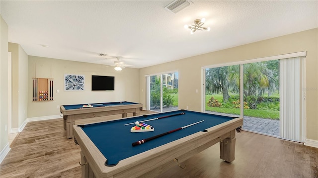 rec room featuring light wood-type flooring, pool table, a textured ceiling, and ceiling fan