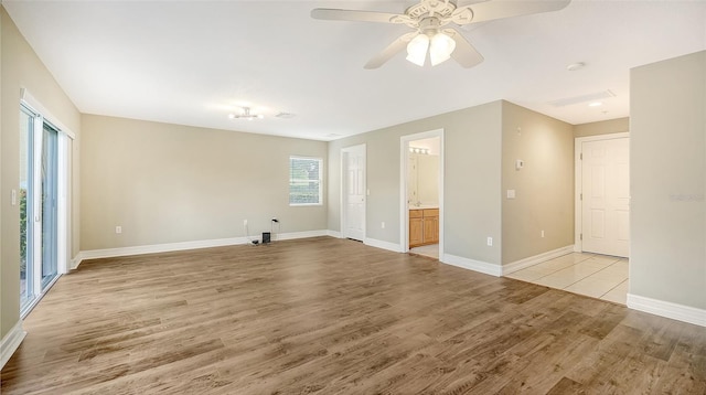 unfurnished living room with ceiling fan and light wood-type flooring