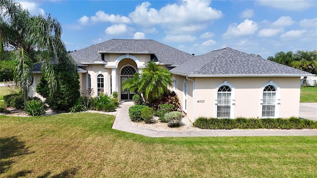 mediterranean / spanish house featuring a front lawn