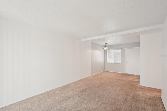 carpeted spare room with a textured ceiling