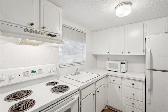 kitchen with white cabinets, white appliances, sink, and a textured ceiling