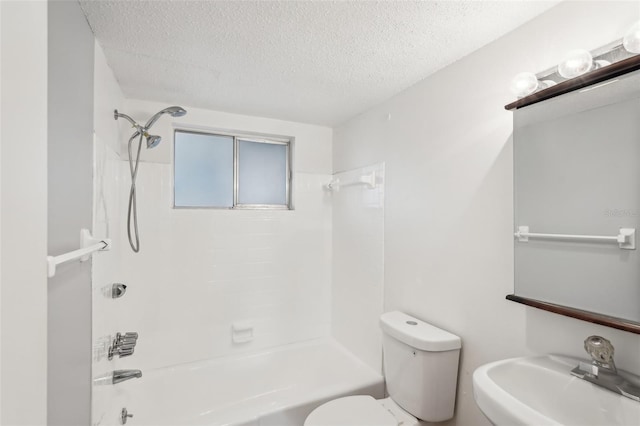 full bathroom featuring a textured ceiling, toilet, sink, and tiled shower / bath