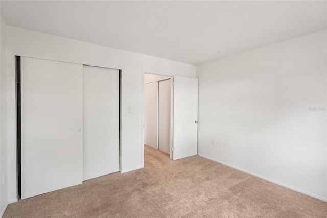 unfurnished bedroom with light colored carpet