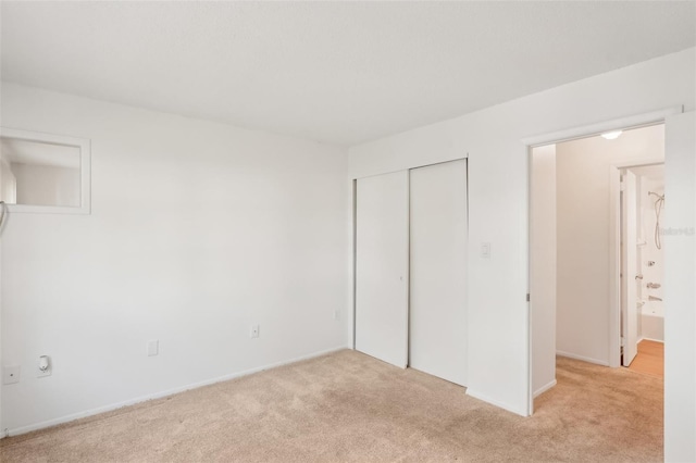 unfurnished bedroom featuring light carpet