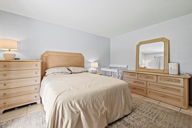 bedroom with light tile patterned floors