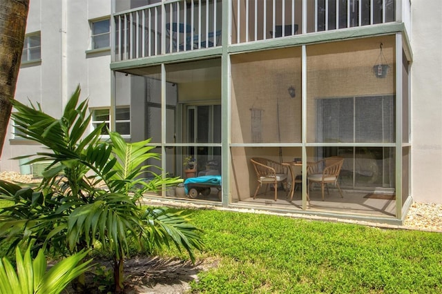 exterior space with a balcony and a sunroom